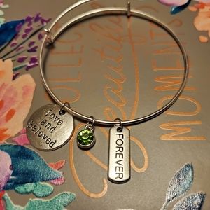Bangle bracelet with charms and gem